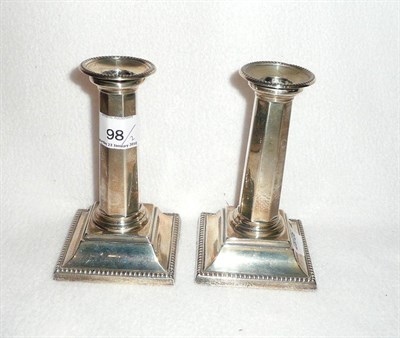 Lot 98 - A pair of small silver candlesticks