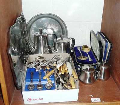 Lot 107 - A silver pill box, cased plated spoons and other plated flatware (small shelf)