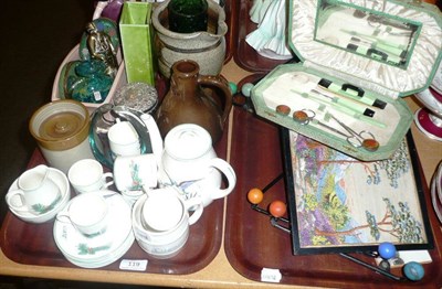 Lot 119 - Two trays of items including a Plichta tea set, silver topped jar, Mdina glass, coat hooks etc