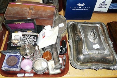 Lot 125 - A tray including silver backed brushes, silver topped scent bottle, enamel dish, silver handled...