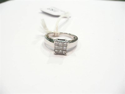 Lot 183 - An 18 carat white gold princess cut diamond cluster ring, the nine diamonds in a tension claw...