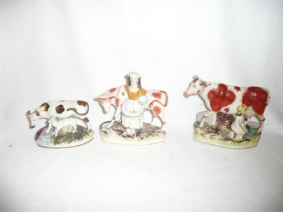 Lot 223 - Three Victorian Staffordshire milk maids and cows