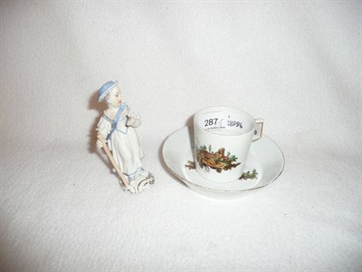 Lot 287 - Furstenberg can and saucer and a Frankesthal figure of a girl