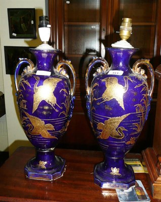 Lot 311 - Pair of blue and gilt two-handled vase lamps