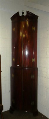 Lot 367 - A George III Mahogany Bowfront Standing Corner Cupboard, the broken pediment centred by an urn...