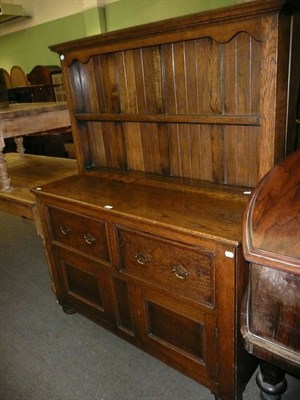 Lot 389 - A reproduction oak dresser, the base with two drawers above two cupboard doors