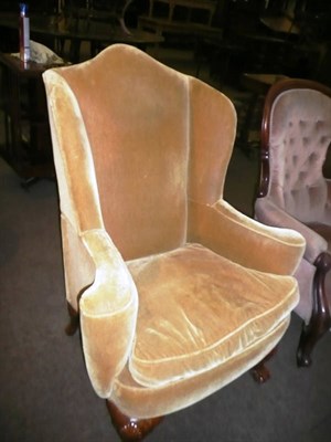 Lot 435 - Mid 20th century upholstered wing-back chair