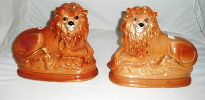Lot 34 - A pair of Staffordshire lions with inset eyes