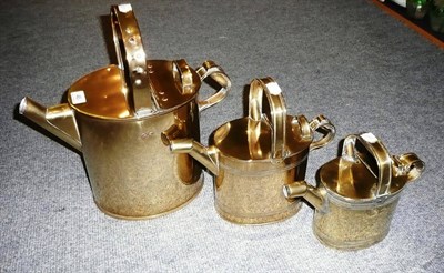 Lot 46 - Three brass watering cans