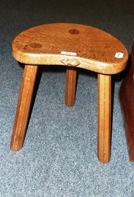 Lot 63 - A Robert 'Mouseman' Thompson oak cow stool on three octagonal legs with carved mouse signature