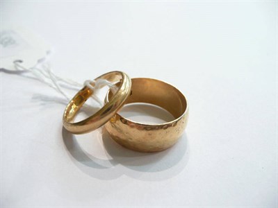Lot 74 - An 18ct band ring and another