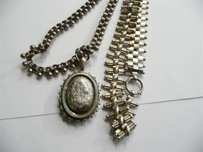 Lot 90 - A silver locket on chain and another chain