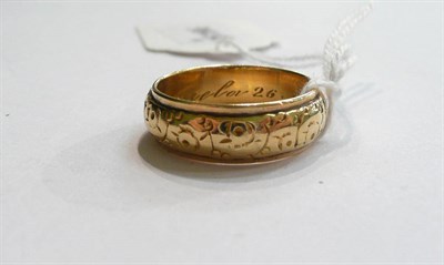 Lot 113 - A patterned band ring stamped '750'