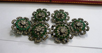 Lot 118 - A set of six paste buttons, of stylised floral form, set with white paste stones with a ring of...