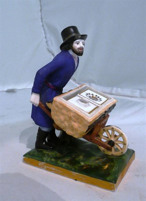 Lot 149 - A Russian porcelain inkwell modelled as a man pushing a wheelbarrow