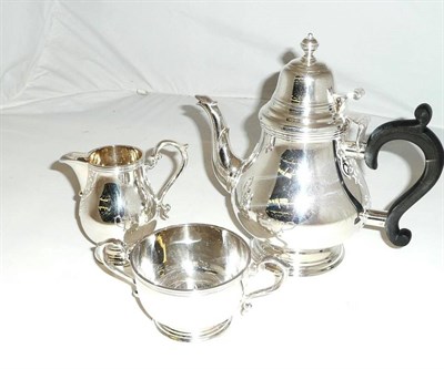 Lot 27 - Silver three piece tea service with applied fret cut detailing