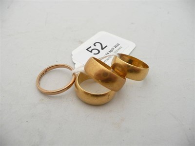 Lot 52 - Three 22 carat gold wedding bands and a 9 carat gold band (4)