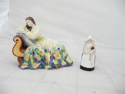 Lot 102 - A Royal Worcester candle snuffer - nun and a Royal Doulton figure - 'Solitude' HN2810 (2)