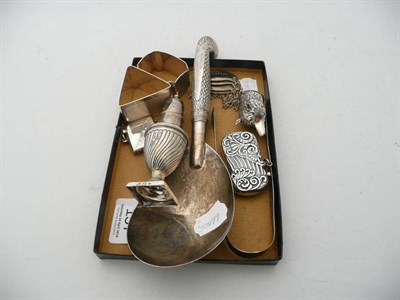 Lot 157 - Four silver bottle labels, two silver napkin rings, a pair of Georgian sugar tongs, a...