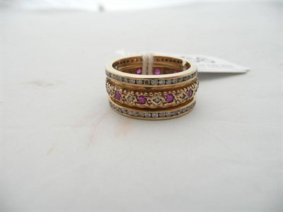 Lot 166 - A 9 carat gold fancy ruby and diamond full eternity ring