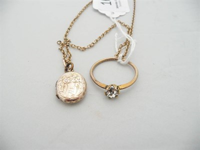 Lot 167 - A locket on chain and a paste set dress ring