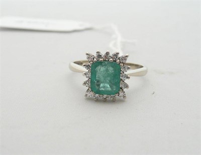 Lot 180 - An 18 carat white gold emerald and diamond ring