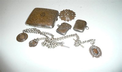 Lot 186 - A silver cigarette case and two vesta cases, two silver watch chains and fobs and a silver...