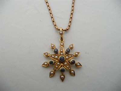 Lot 192 - A sapphire and seed pearl star pendant on an oval belcher necklace stamped "9CT", 9.1grams...