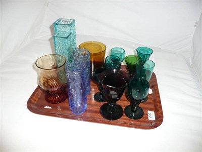 Lot 200 - A tray of fourteen coloured glass items including emerald and amethyst wines, Whitefriars type...