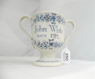 Lot 250 - A Swinton pearlware pottery loving cup, John White Born 1787, the strap handles with leaf...