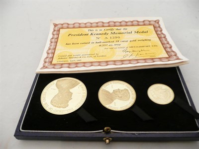 Lot 273 - Three 18 carat gold Kennedy medals, cased with certificates