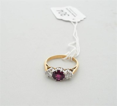 Lot 304 - A ruby and diamond three stone ring