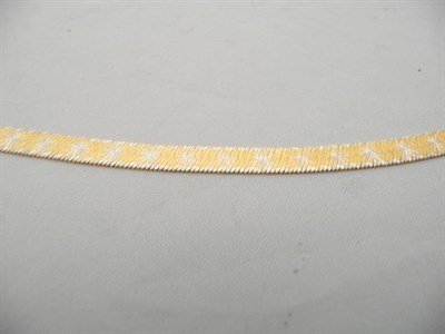 Lot 420 - A two colour diamond cut fancy bracelet stamped "750"