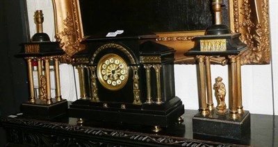 Lot 562 - A three piece black slate clock garniture