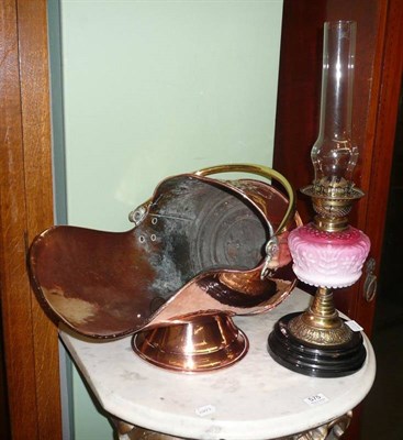 Lot 576 - Embossed copper and brass coal bucket, oil lamp and two chimneys