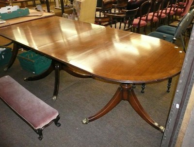 Lot 628 - A reproduction mahogany triple pedestal dining table