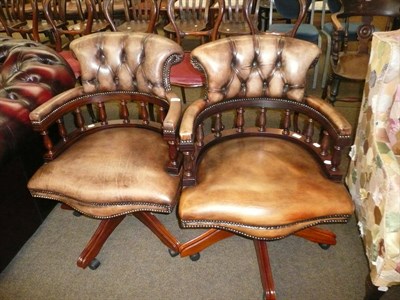 Lot 645 - Pair of modern brown leather swivel armchairs