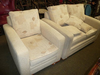 Lot 652 - Modern two seater settee and matching chair in cream draylon