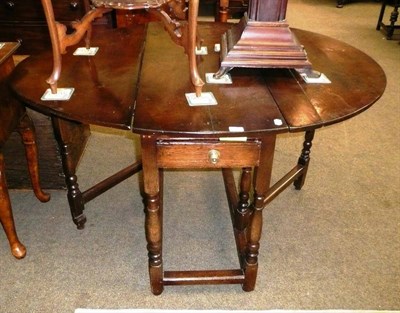 Lot 666 - An Oak oval gateleg dining table with alterations