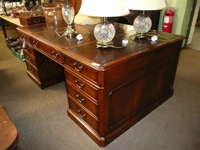 Lot 702 - A reproduction mahogany partner's desk in George III style