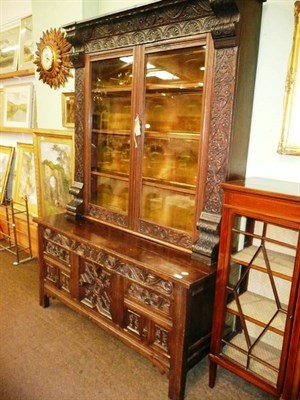 Lot 707 - Carved oak bookcase on cupboard base, initialled and dated 1690