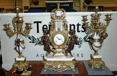 Lot 715 - A three piece French-style gilt metal clock garniture