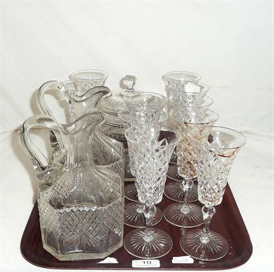 Lot 10 - Tray of champagne flutes, a pair of cut glass jugs and a biscuit barrel