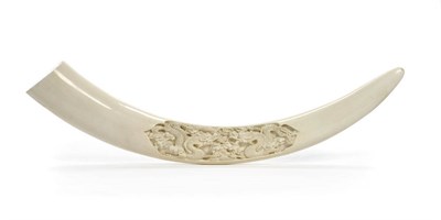 Lot 1016 - A Chinese Carved Elephant Tusk, circa 1965, the plain tusk carved in deep relief on one side...