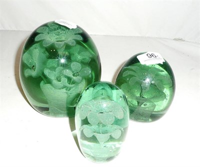 Lot 96 - Three green glass dump paperweights
