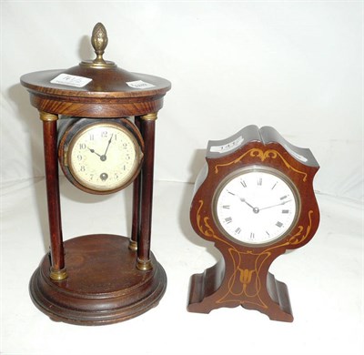 Lot 141 - An Edwardian mahogany inlaid tulip mantel clock and an oak clock