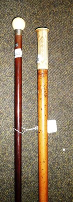 Lot 241 - Two ivory-topped walking sticks one with a compass