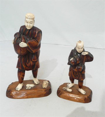 Lot 277 - Two carved ivory and boxwood figures of fruit gatherers