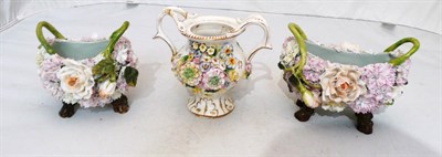 Lot 302 - A Coalbrook floral encrusted twin handled vase and two Continental floral encrusted baskets (3)