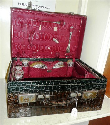 Lot 334 - Crocodile skin-cased silver-mounted dressing set